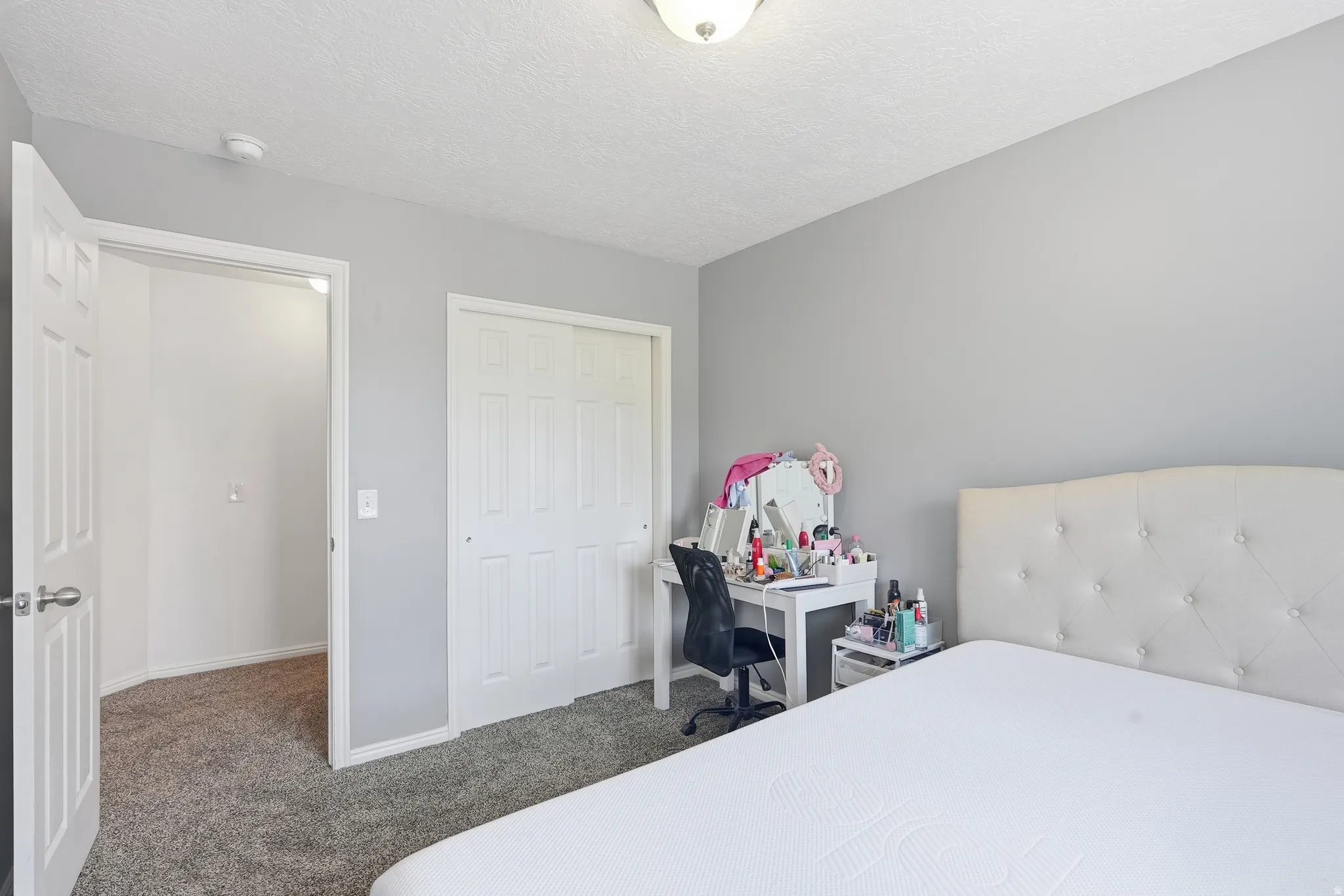 Bedroom featuring light gray walls, gray carpet, and white trim