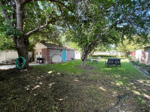 Spacious backyard featuring mature trees