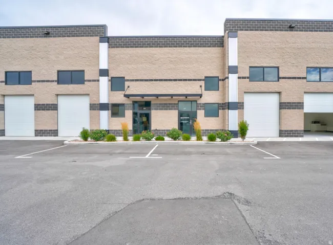 Commercial building exterior featuring light-colored block facade with dark brick accents