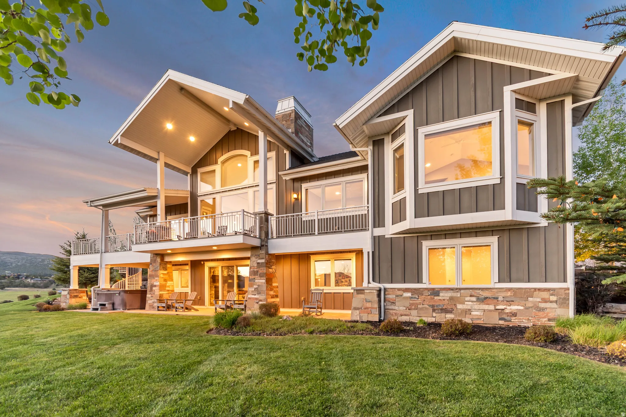 Modern multi-level exterior with board and batten siding and stone accents