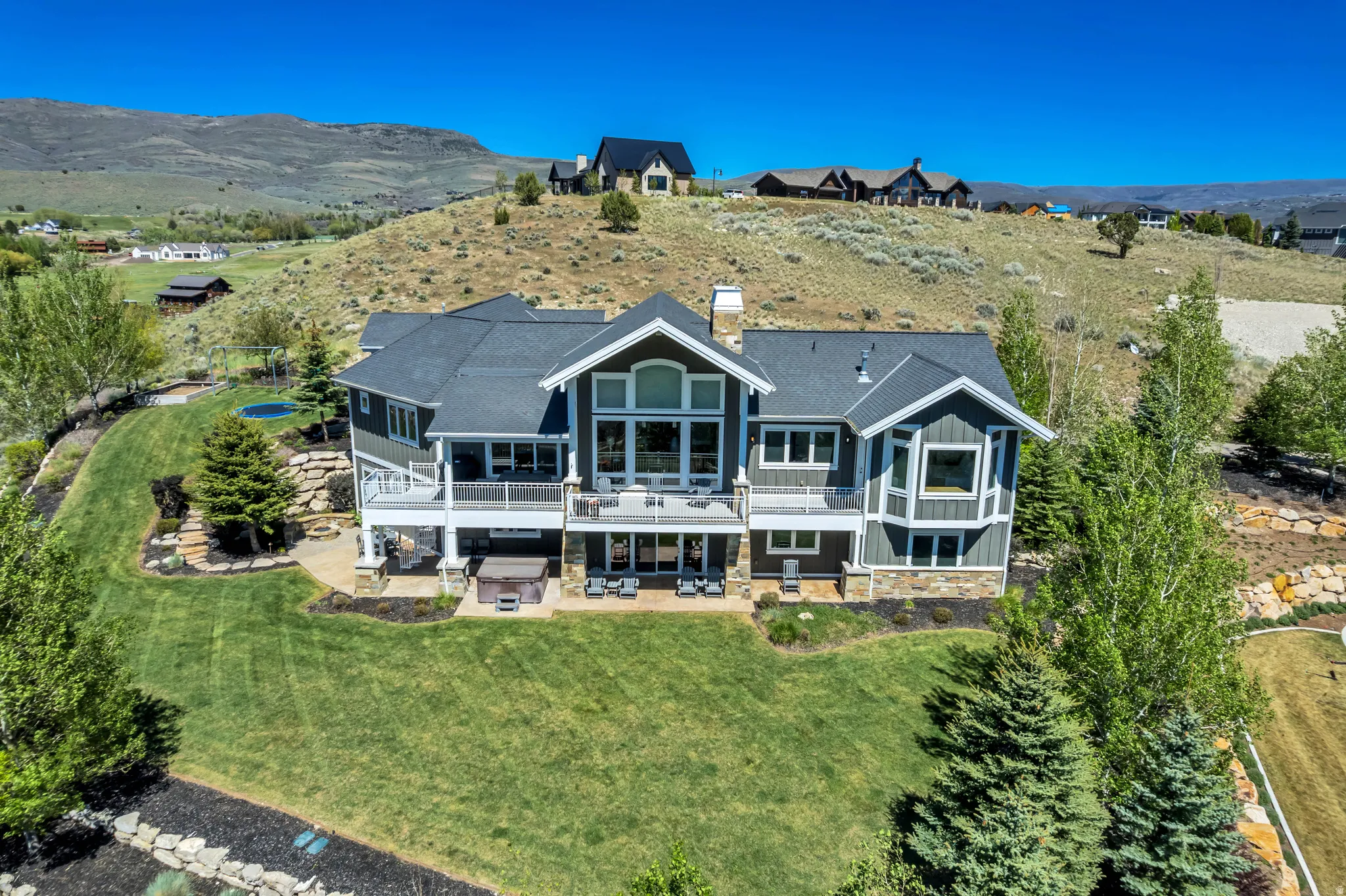 Expansive multi-level residence with dark siding and white trim