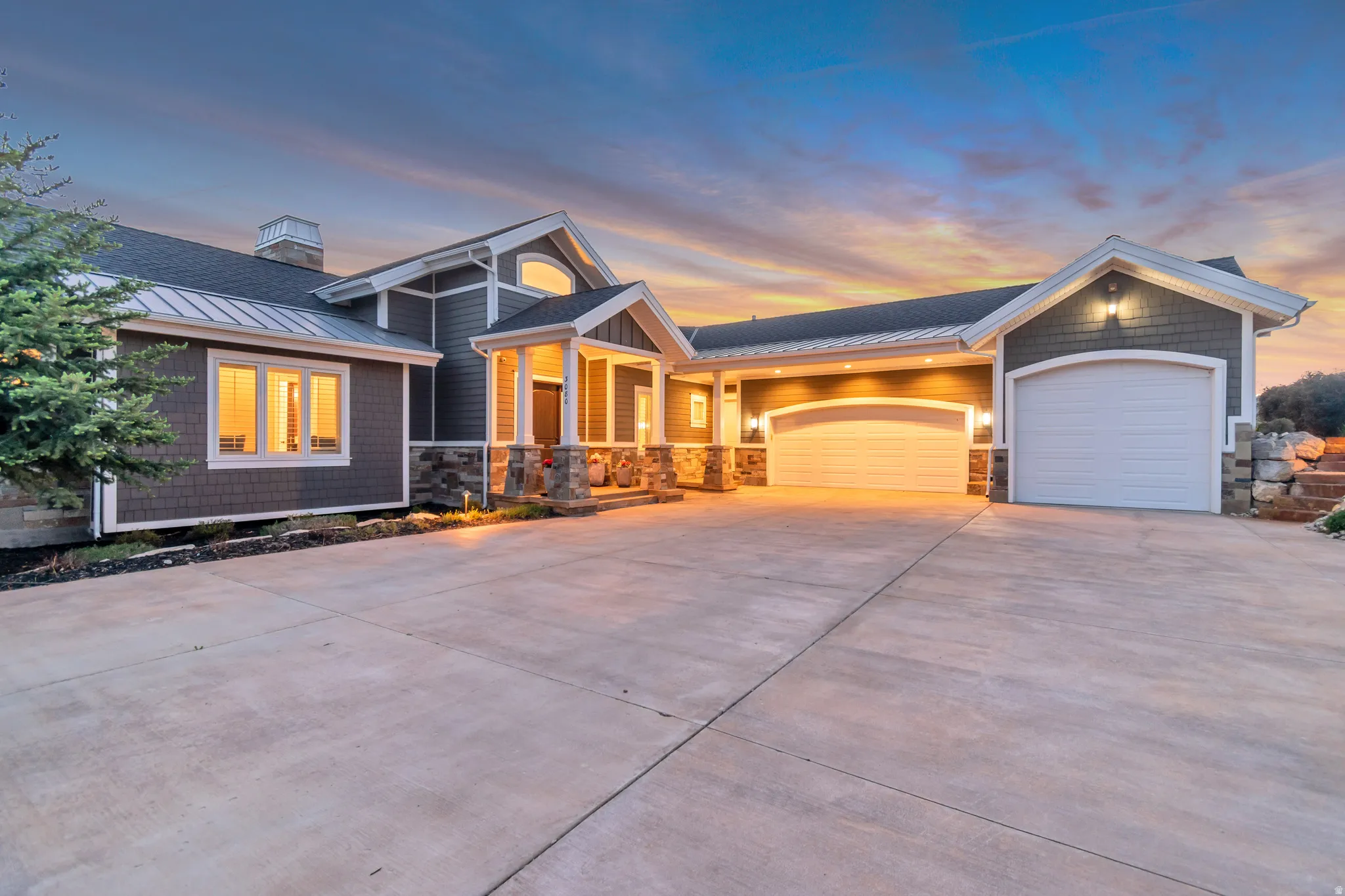 Craftsman-style exterior with gray siding and stone accents