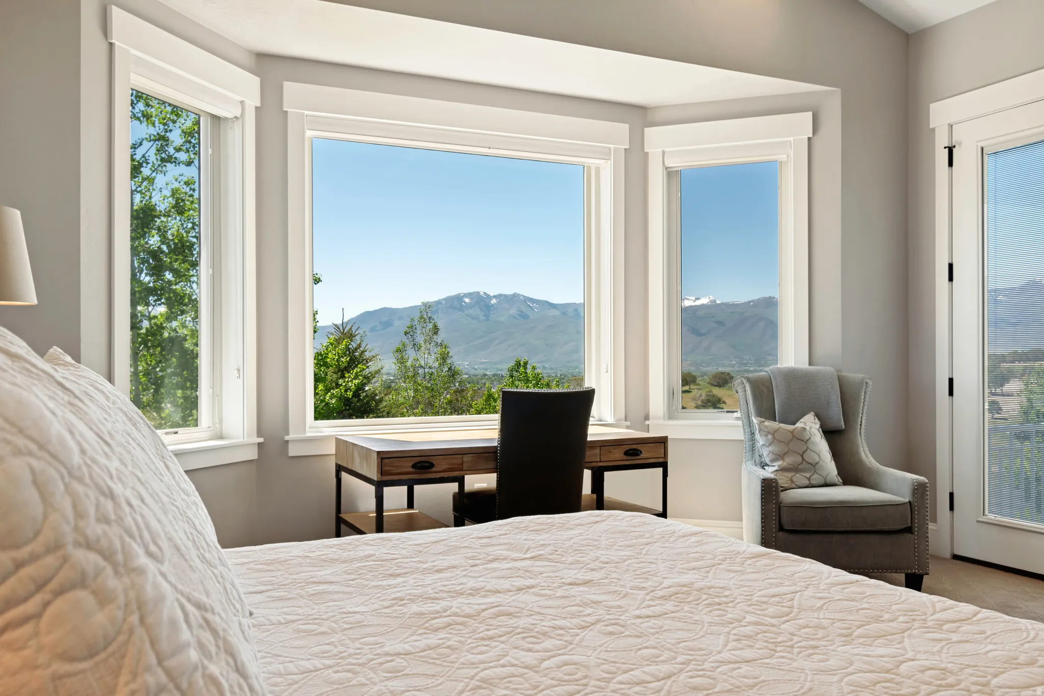 Expansive bay window framing distant mountains and surrounding greenery