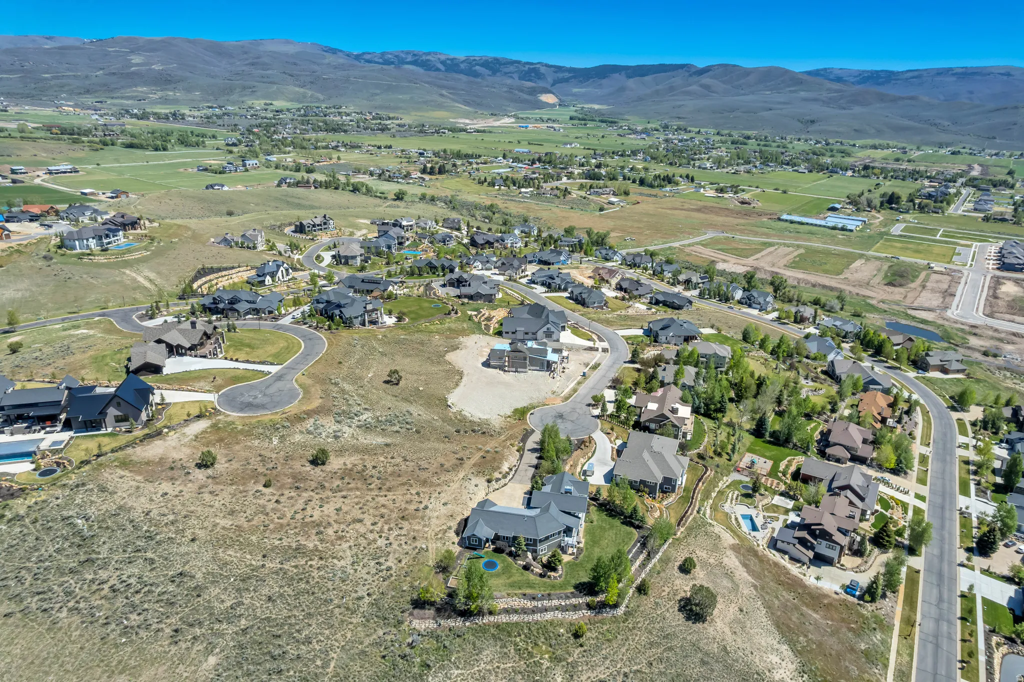 Expansive aerial perspective showcasing a developed residential area with numerous custom homes