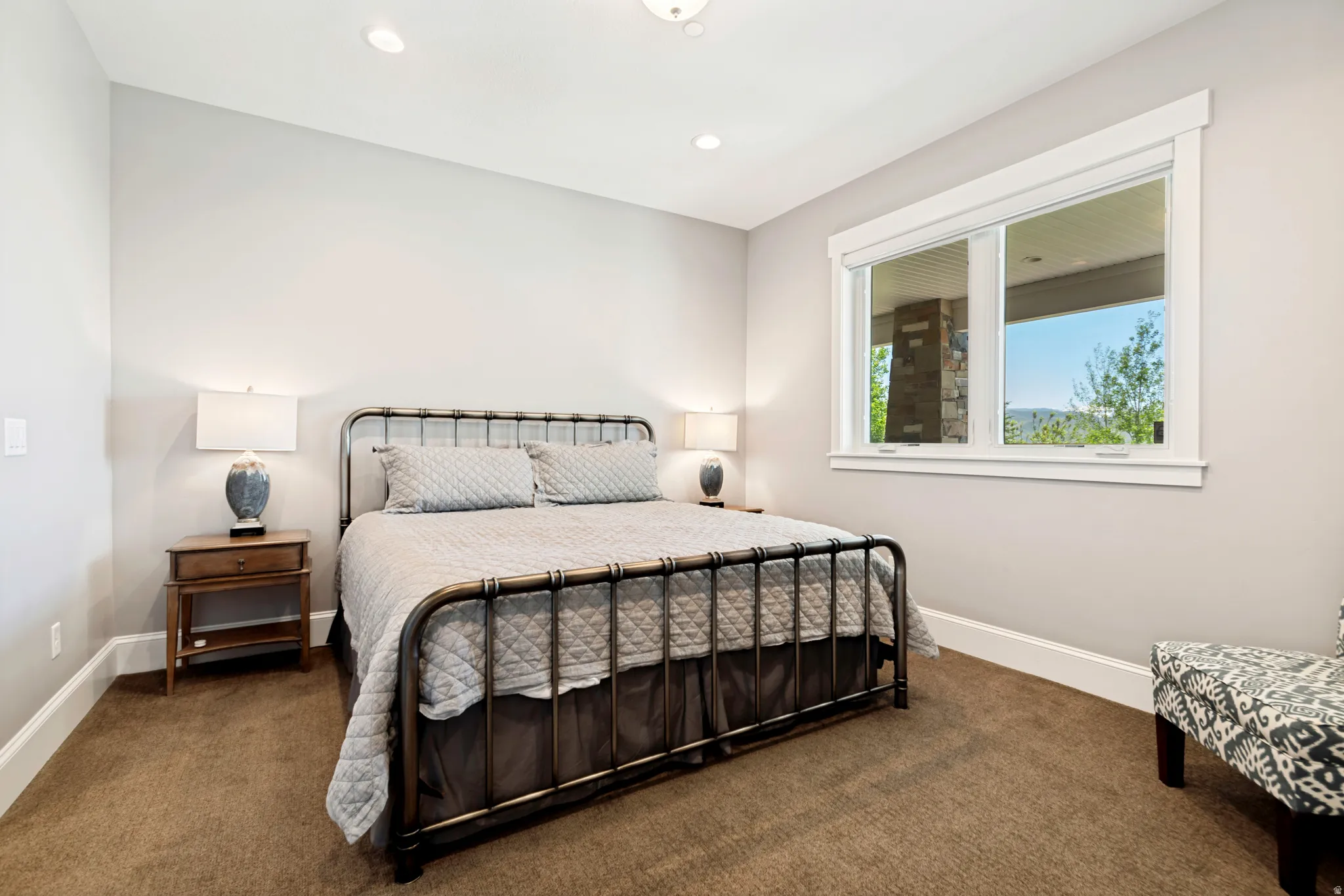 Carpeted interior space featuring light gray walls and white trim
