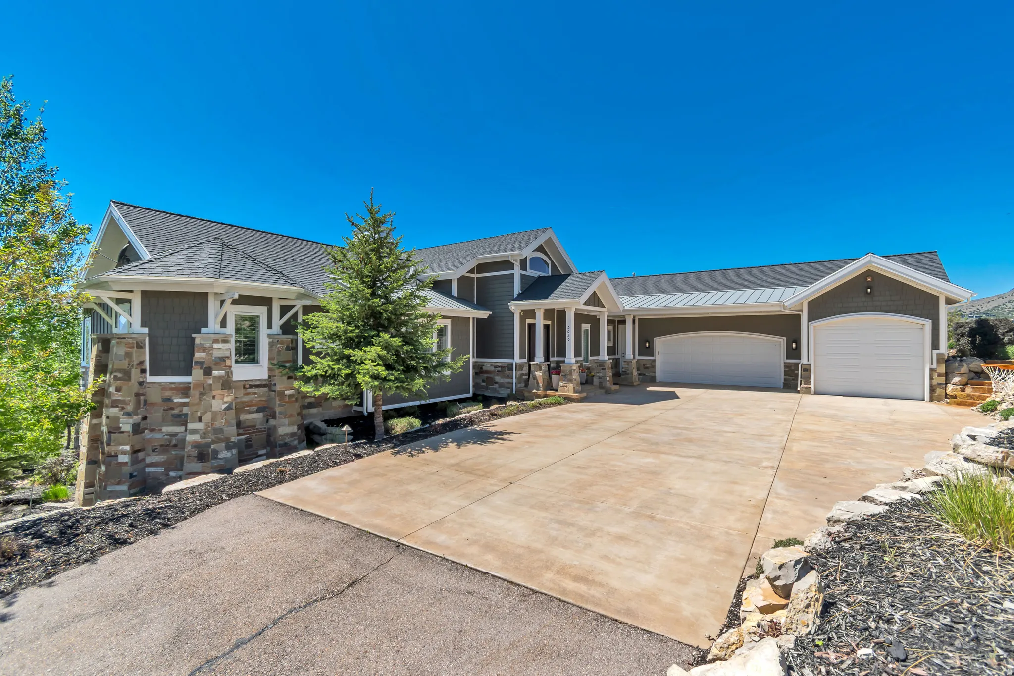 Contemporary exterior with varied siding textures and stone accents