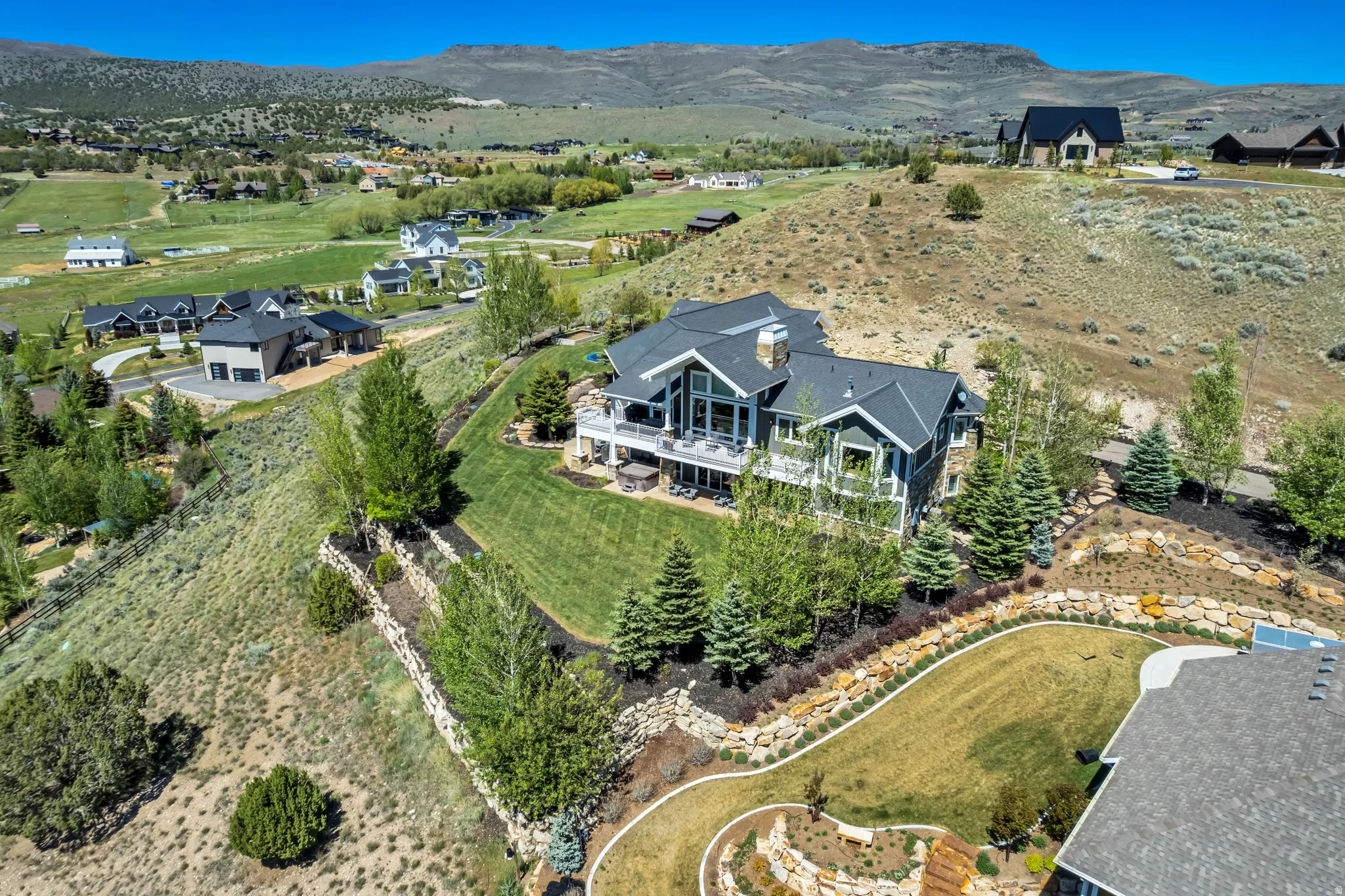 Expansive property featuring a multi-level residence with a dark-toned exterior and a light-toned trim
