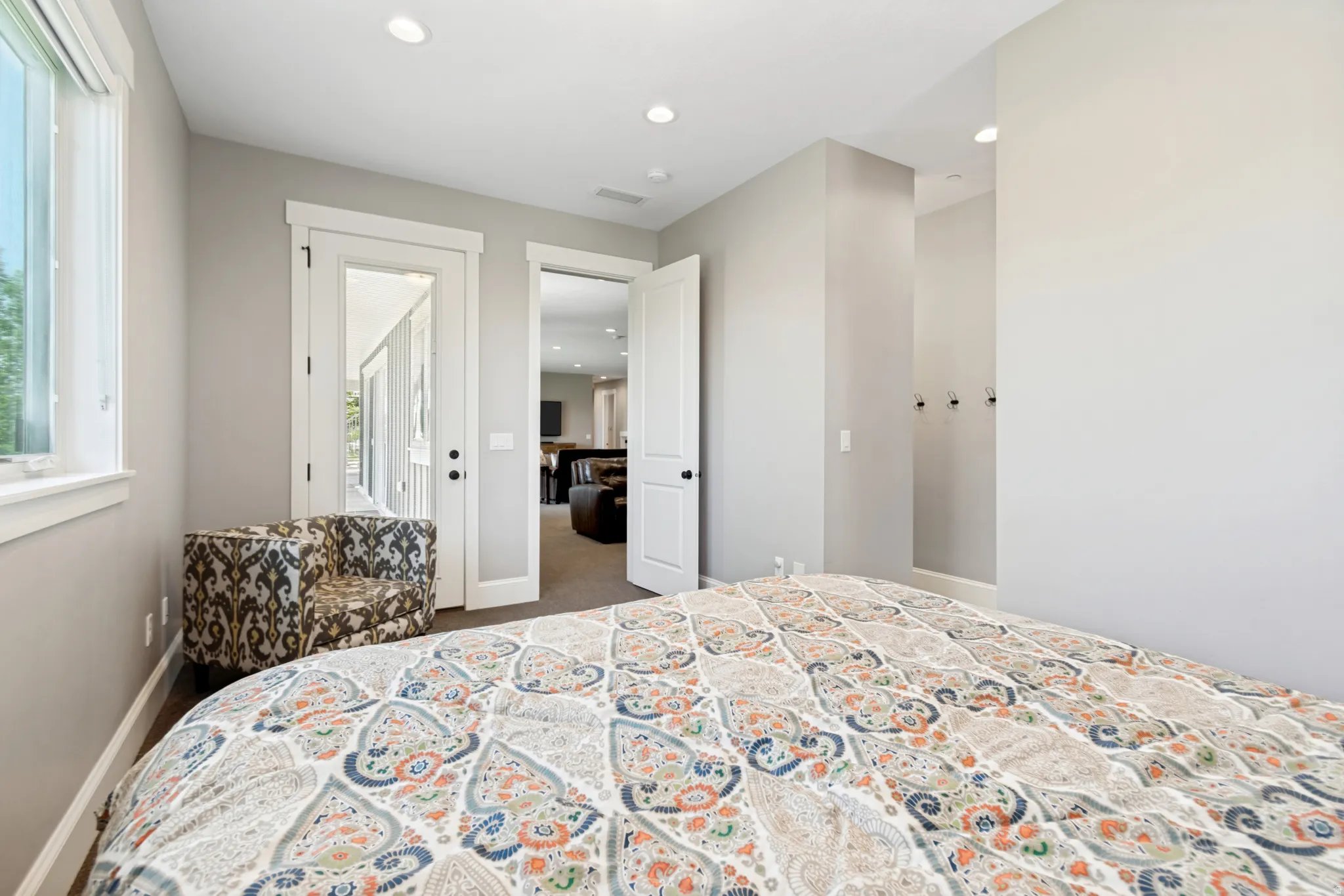 Bedroom featuring light gray walls, recessed lighting, and white trim