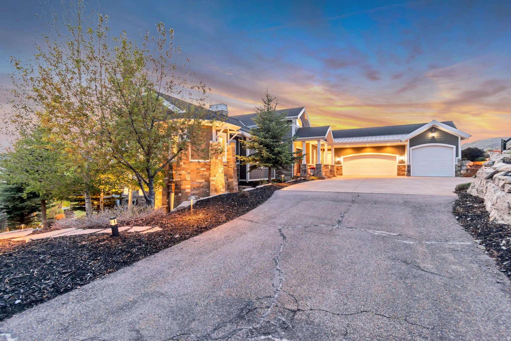 Spacious driveway leading to an attached three-car garage