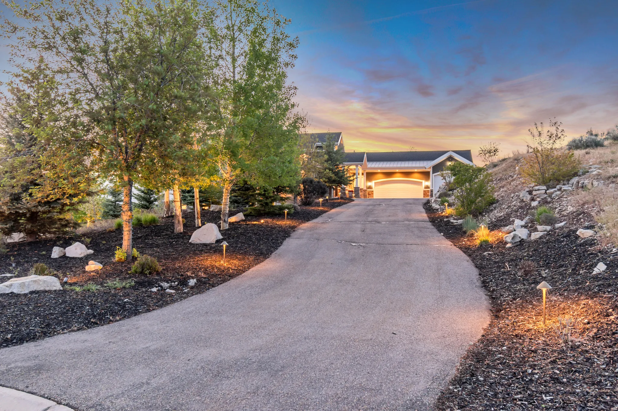 Asphalt driveway with integrated landscape lighting