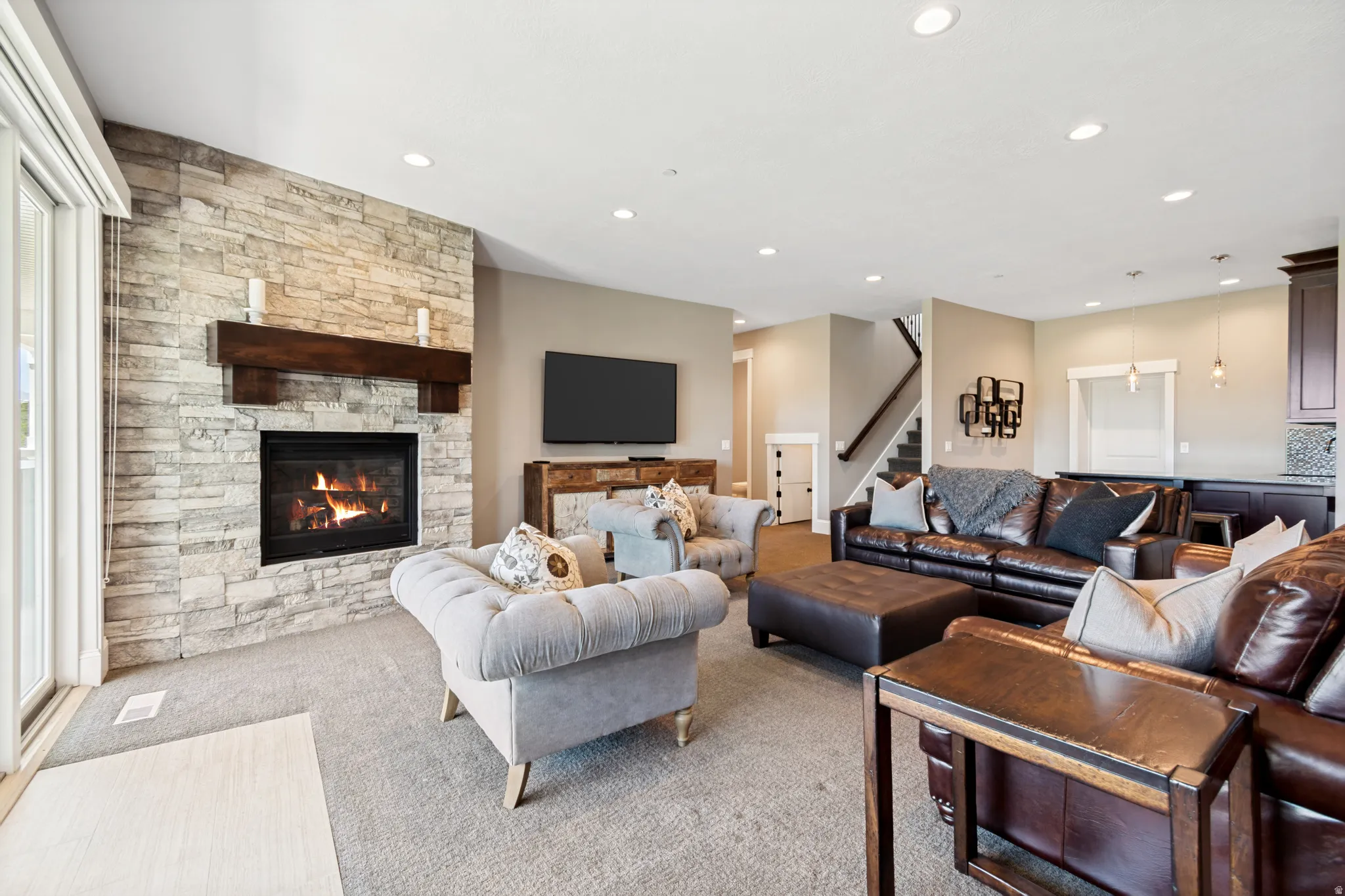 Stone-clad fireplace with a substantial wood mantel