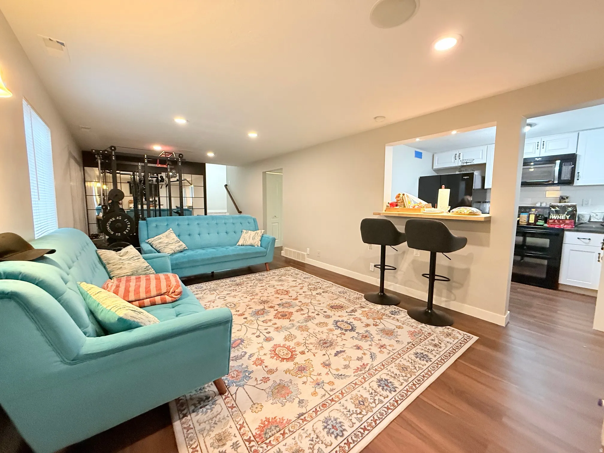 Open-concept living space featuring wood-finish flooring and recessed lighting