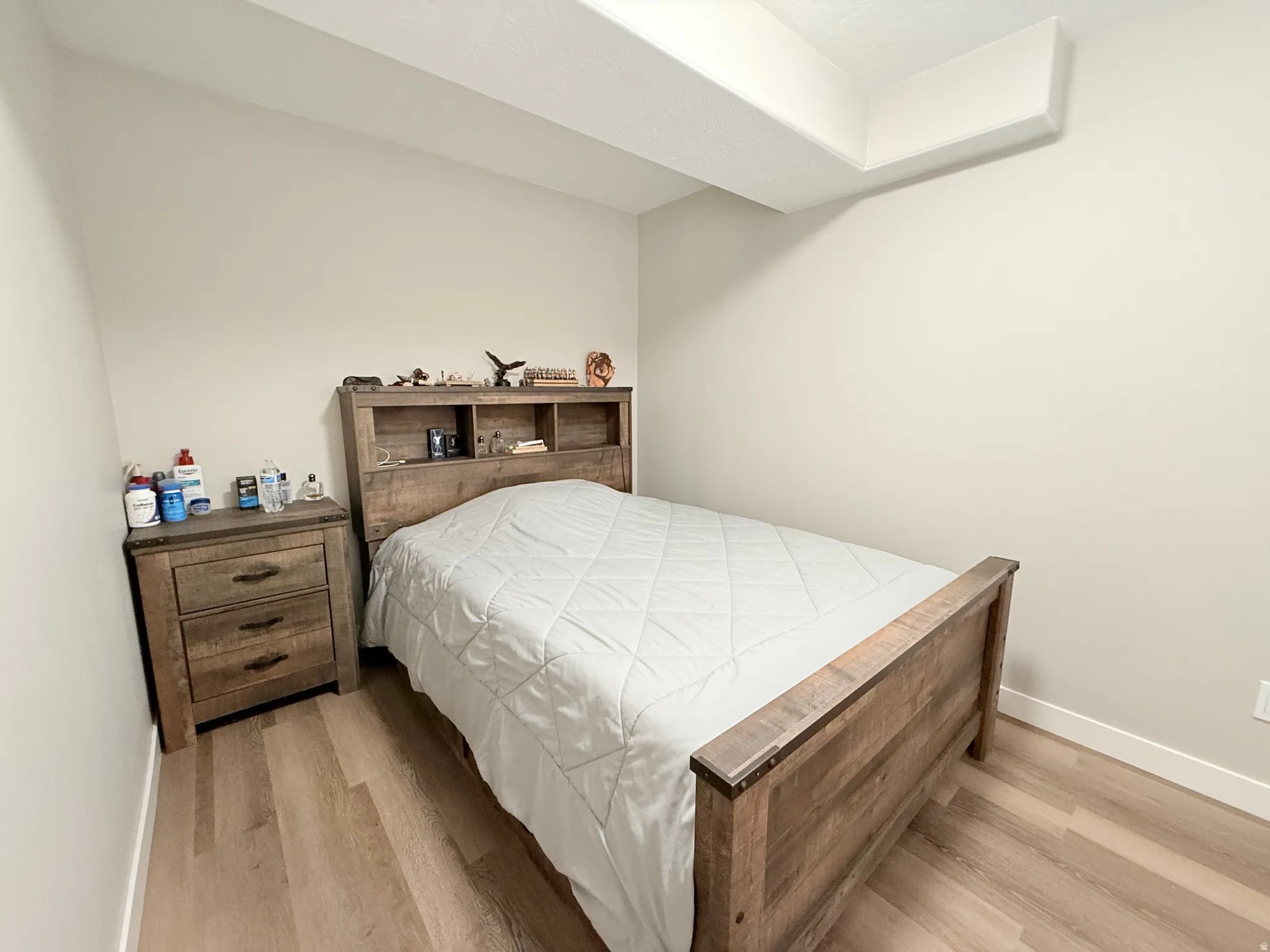 Neutral wall paint, wood-finish flooring, and white baseboards