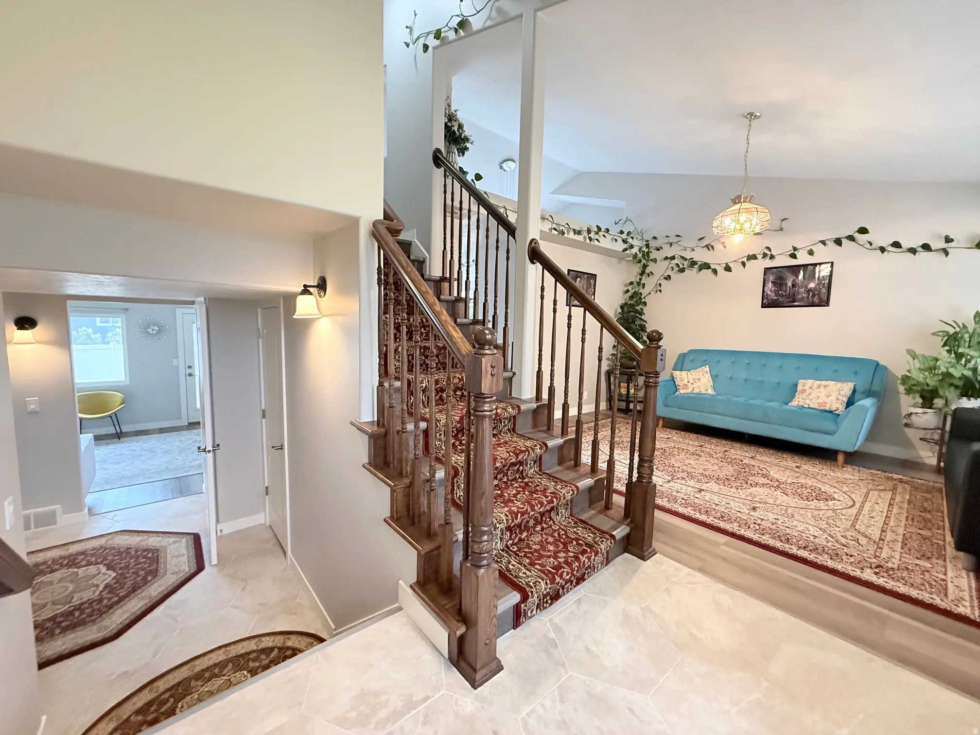 Grand entryway featuring a staircase with a detailed wood banister and carpeted treads