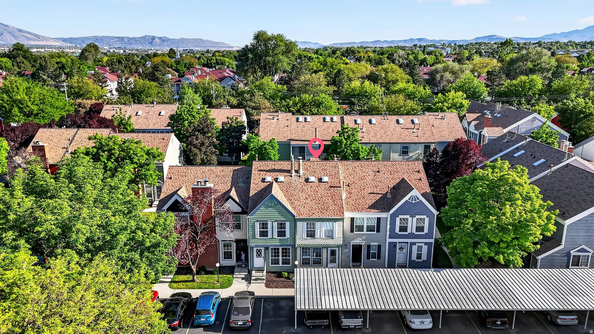 Townhome community featuring varied architectural facades, pitched roofs, and mature landscaping