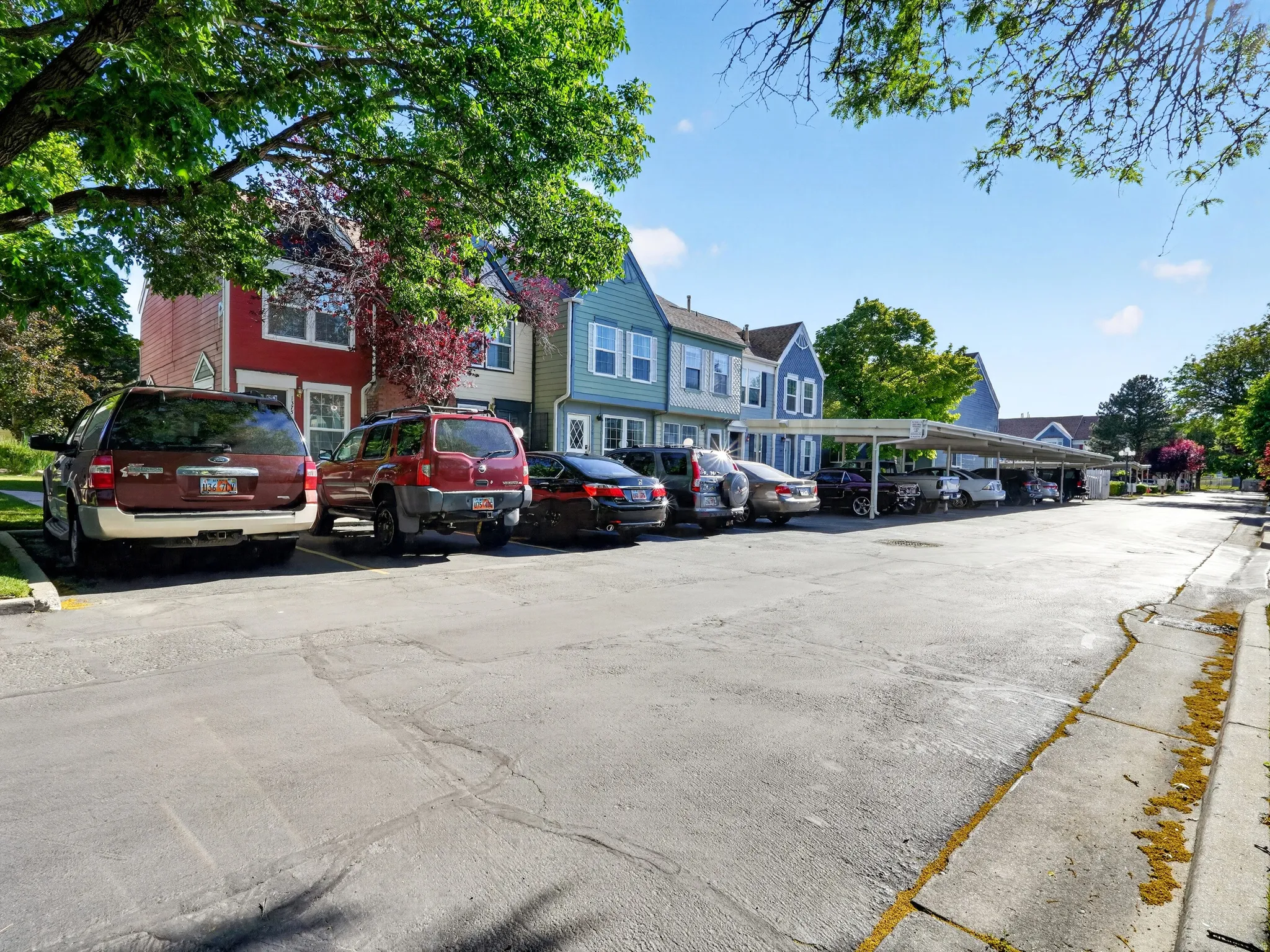 Paved parking area featuring covered parking structures