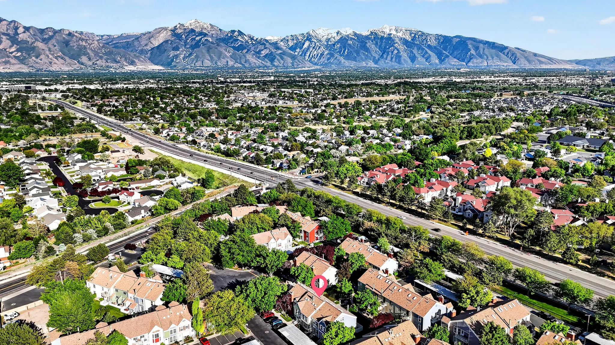 Expansive aerial perspective showcasing a residential area with a prominent highway