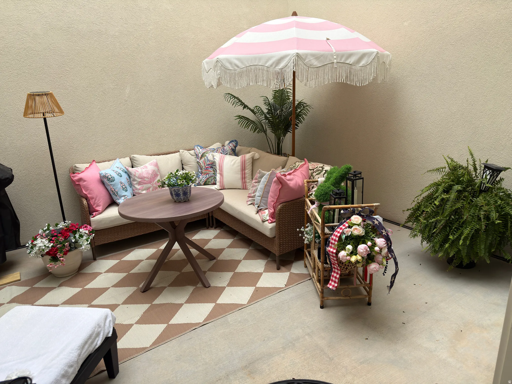 Private patio space featuring a neutral stucco wall