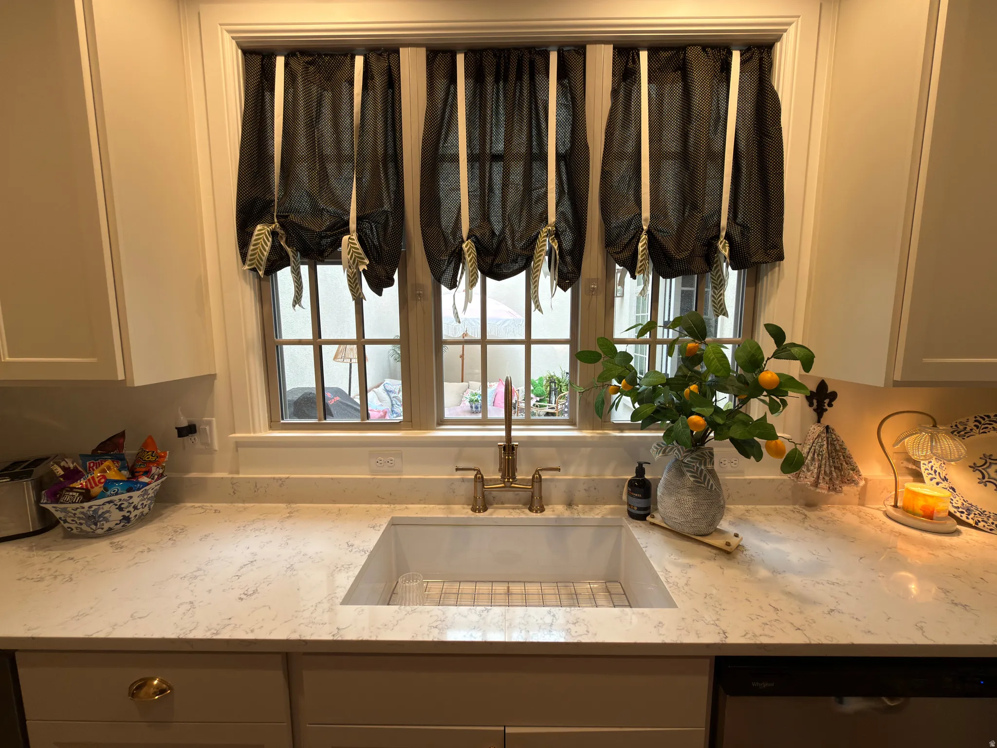 Kitchen workstation with an integrated apron-front sink and a gooseneck faucet