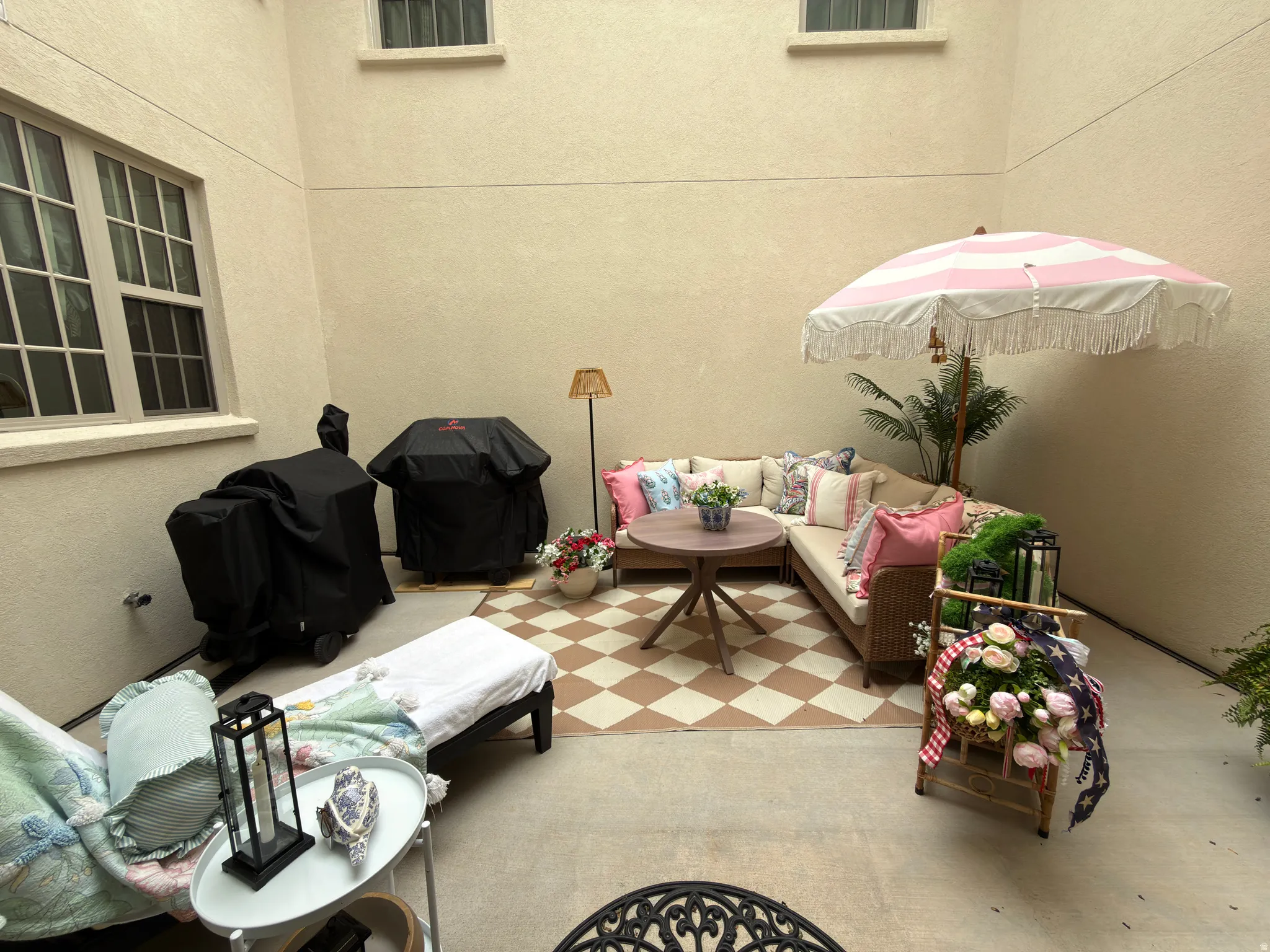 Paved courtyard featuring stucco walls and upper-level windows