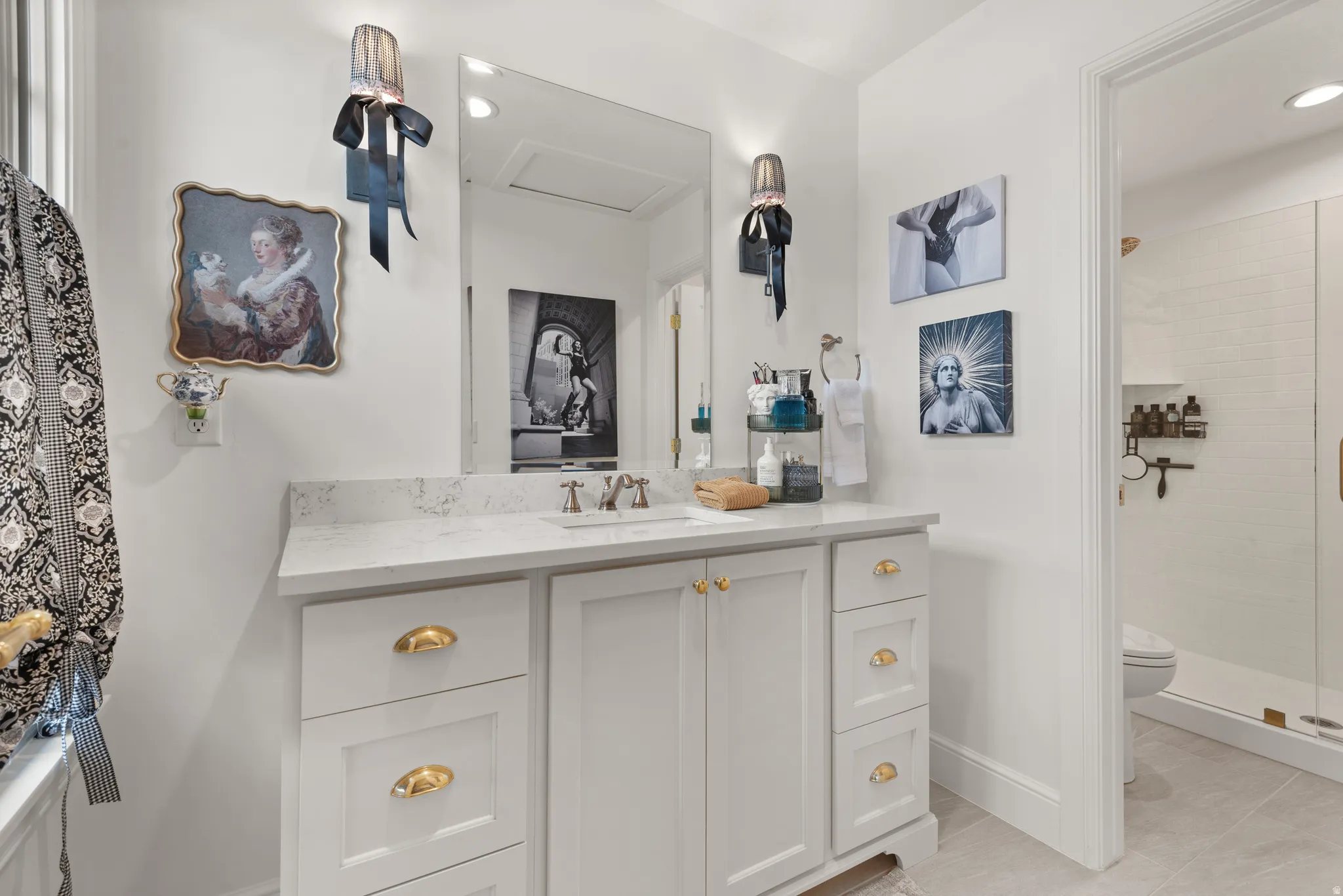 Master bathroom featuring a single vanity with stone countertop, an undermount sink, and brushed nickel faucet