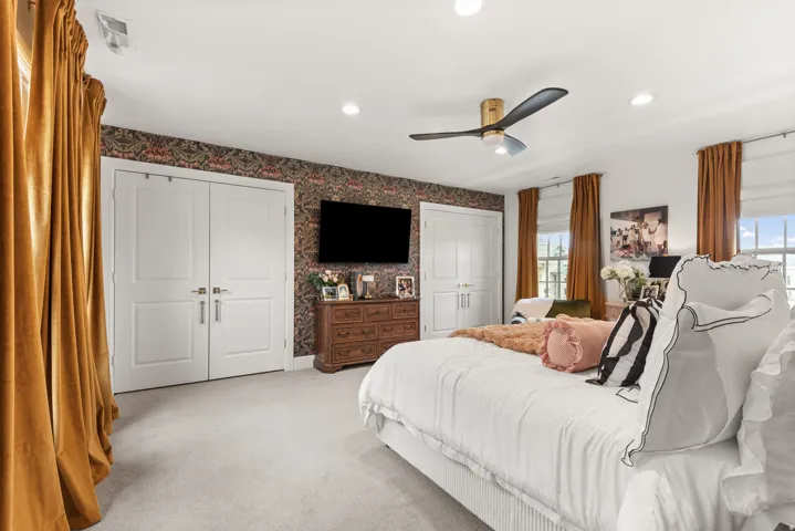 Oversized master bedroom with an abundance of natural lighting.