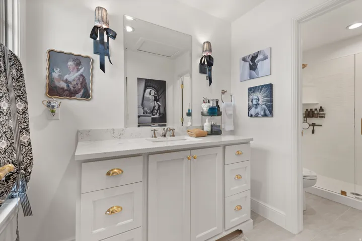 Master bathroom featuring a single vanity with stone countertop, an undermount sink, and brushed nickel faucet