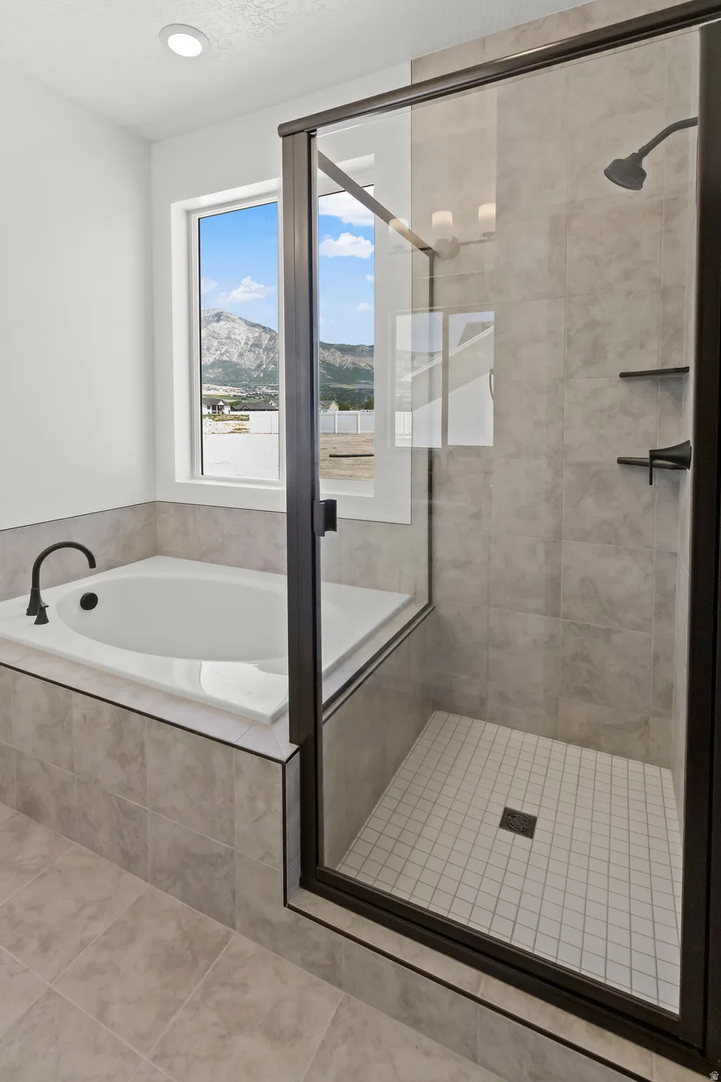 Primary Suite Bathroom w/ separate tub & shower.
