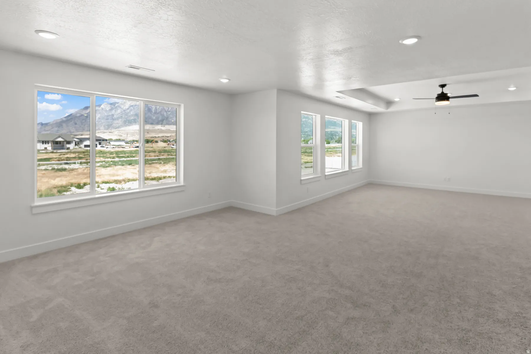 Expansive room featuring multiple windows and an amazing view of the mountains!