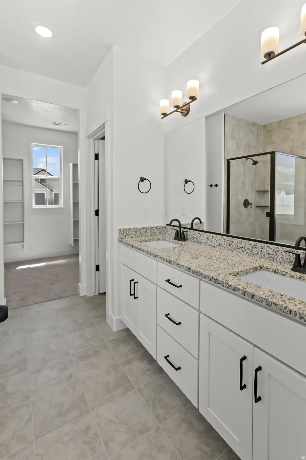 Dual vanity white shaker cabinetry, and matte black hardware