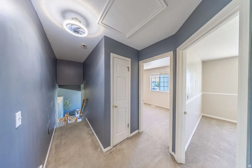 Upstairs hallway with hall ceiling light-fan feature.