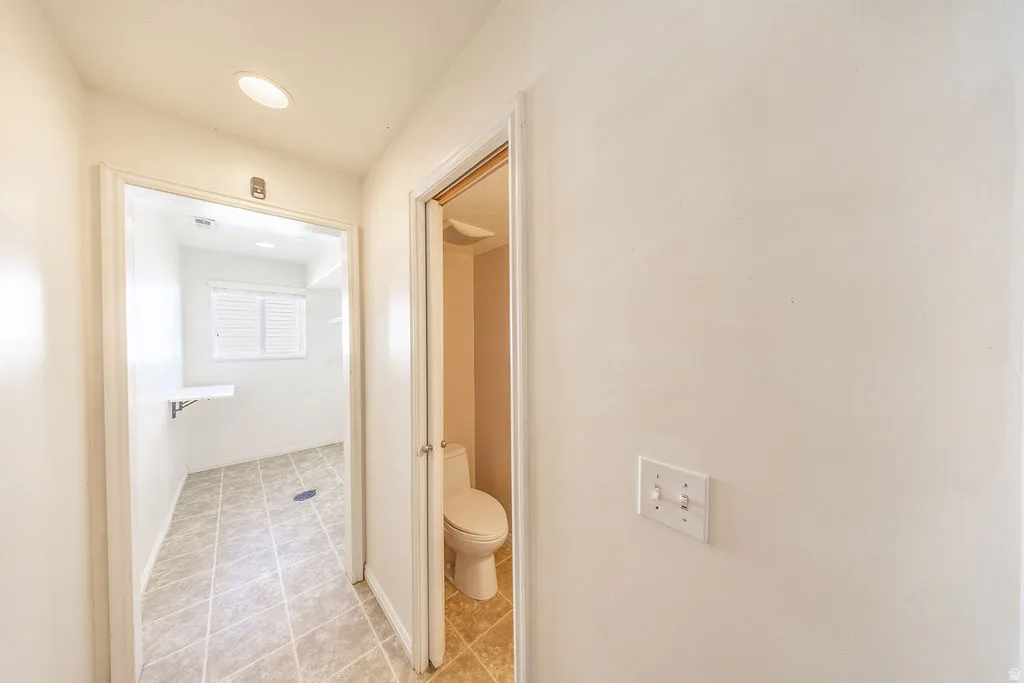 Easy access half bath off of entrance from garage and separate from laundry room.