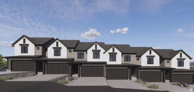 Contemporary townhomes featuring dark gray garage doors, white and tan siding, and dark trim accents