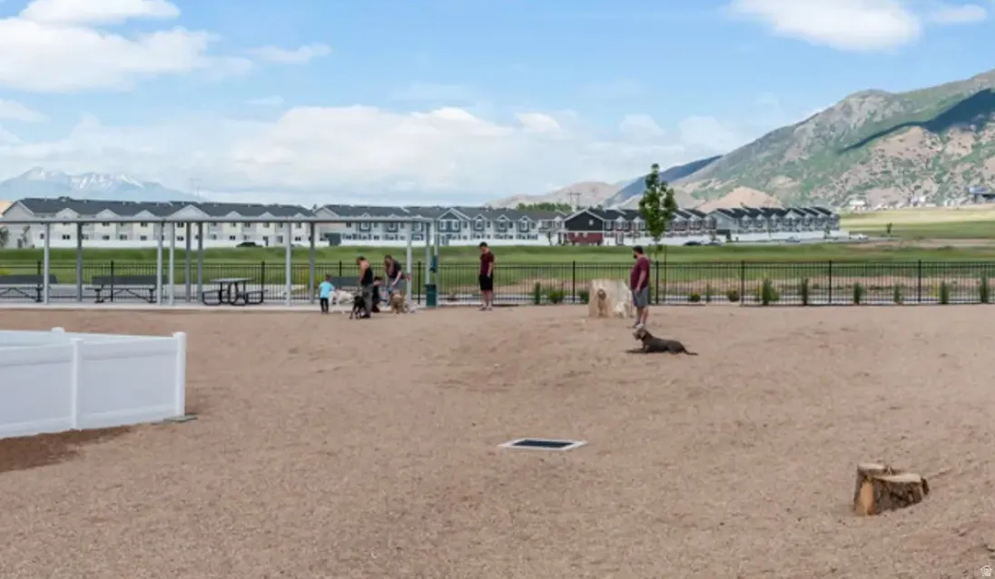 Community recreation area featuring a fenced-in, gravel-surfaced space