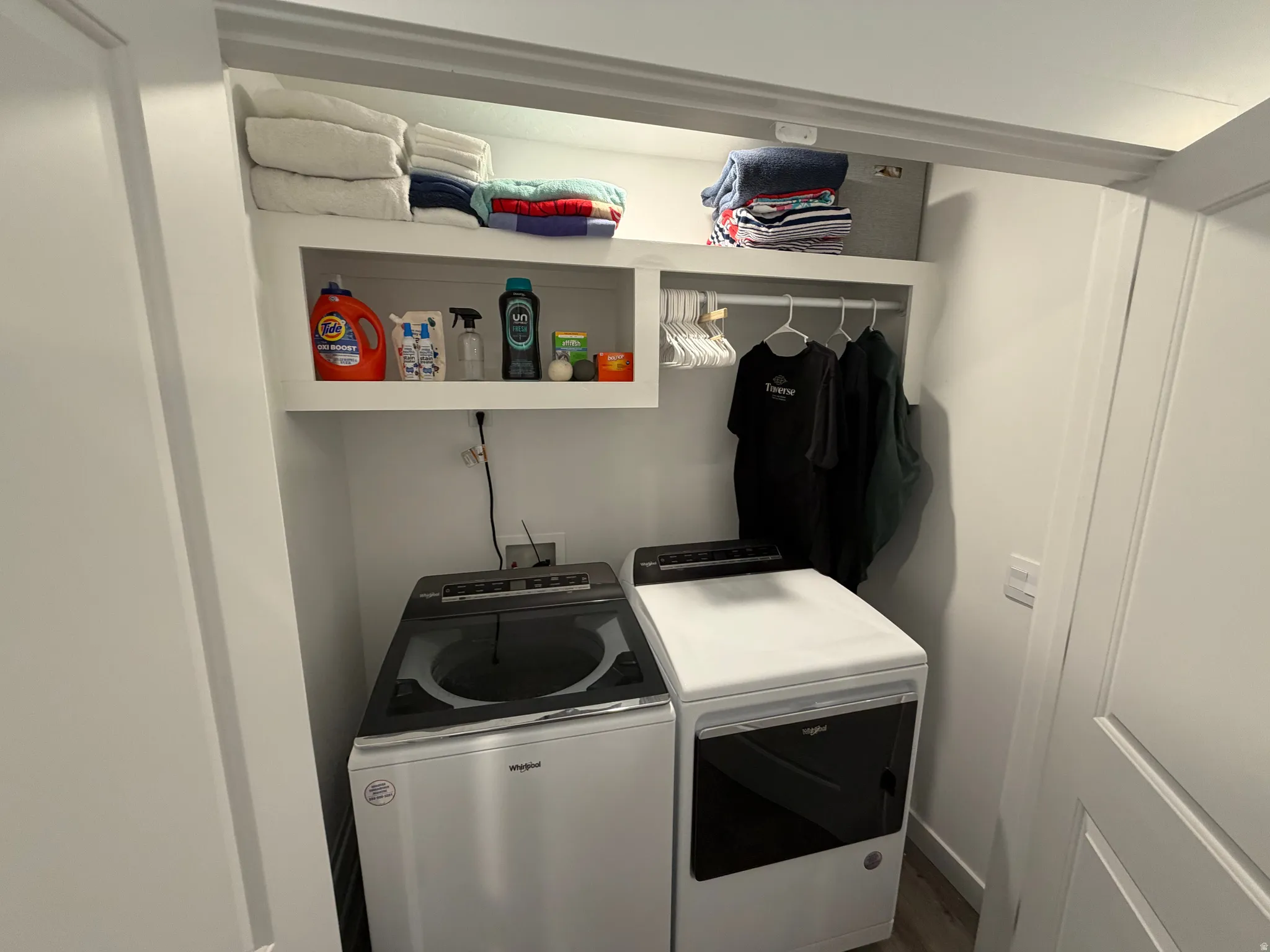 Dedicated laundry area featuring a top-load washing machine and front-load dryer