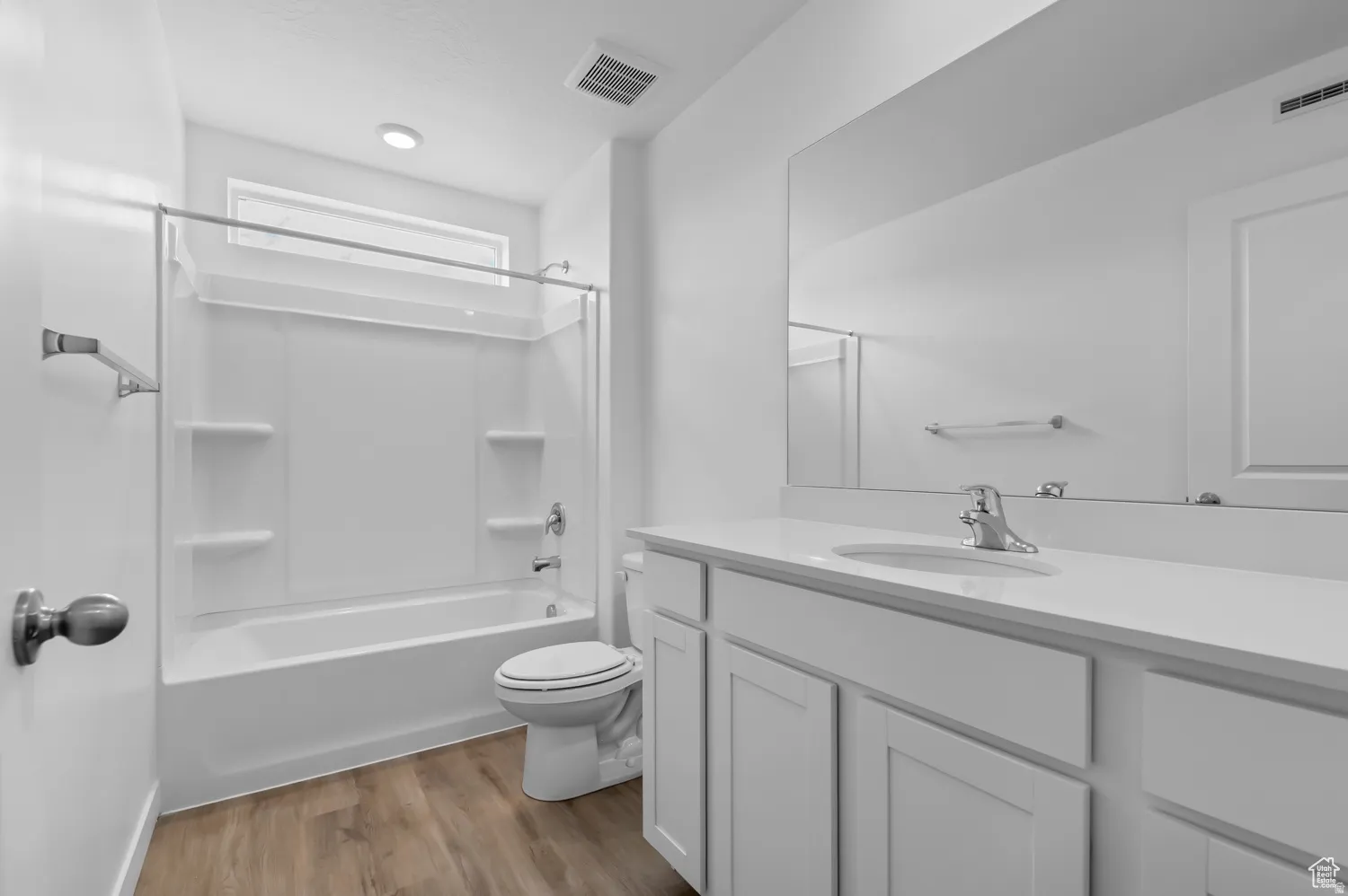 Bathroom with a white tub-shower combination, recessed lighting, and a window above the shower