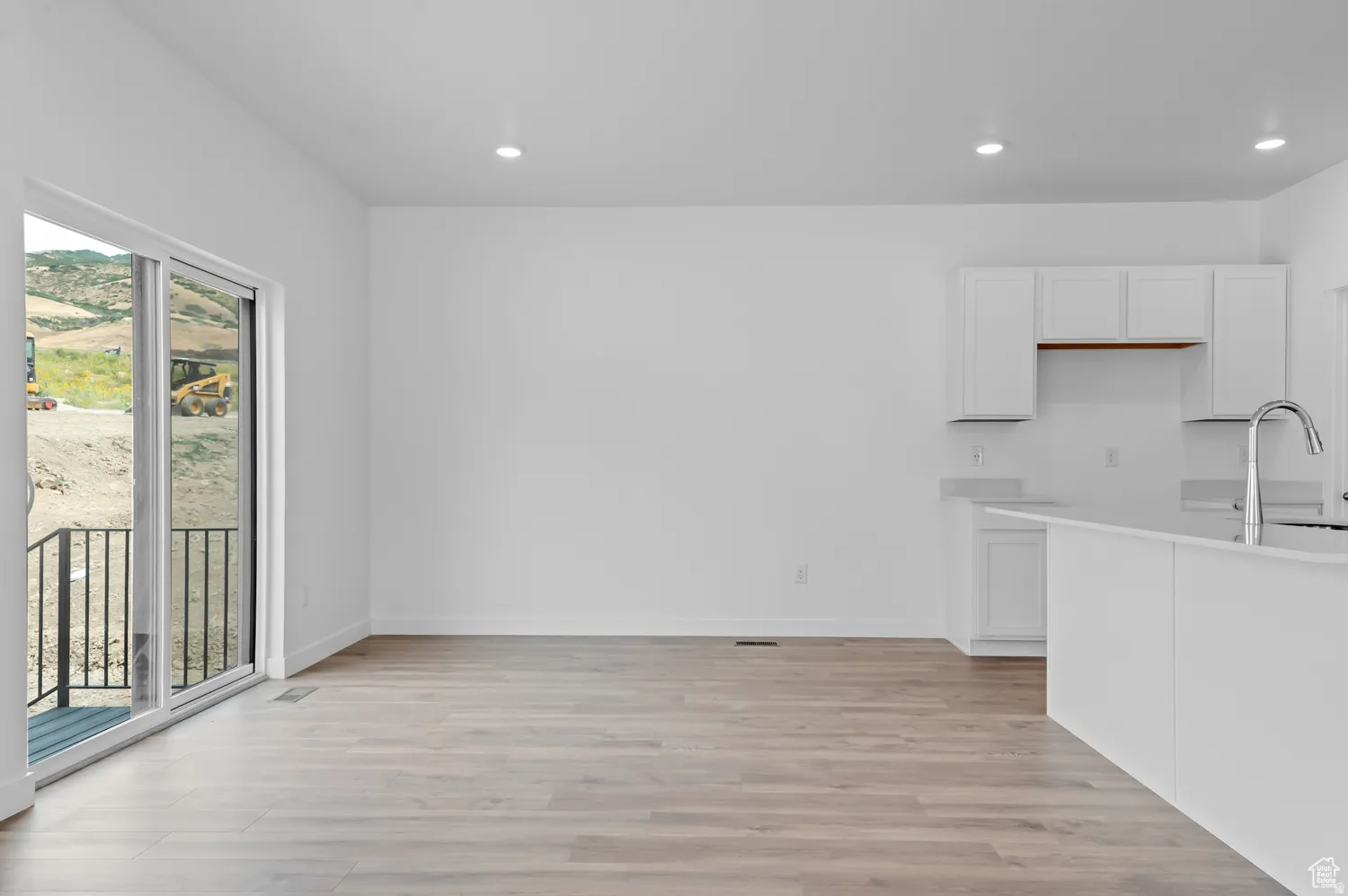 Open-concept living space featuring wood-finish flooring and recessed lighting