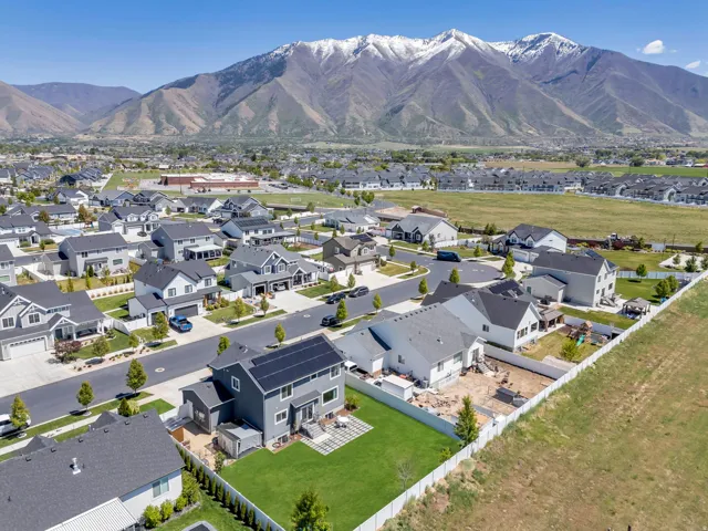 Modern residential community featuring varied architectural styles and an expansive mountainous backdrop