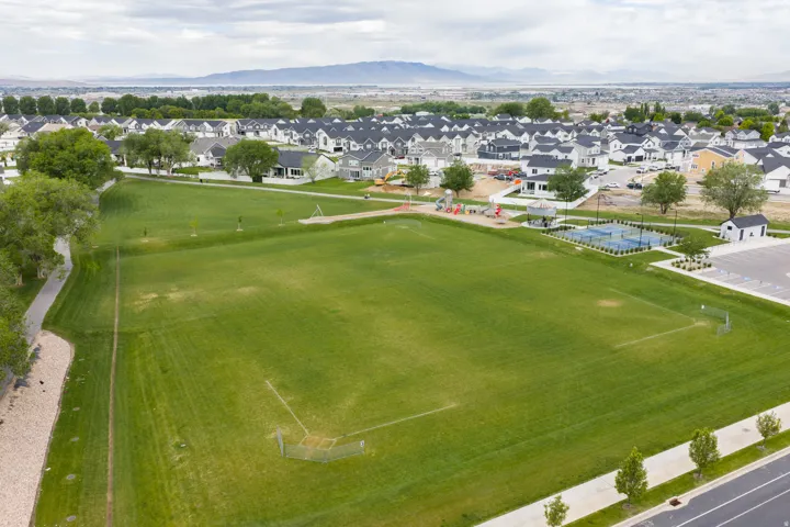 Expansive community green space featuring manicured lawns and walking paths
