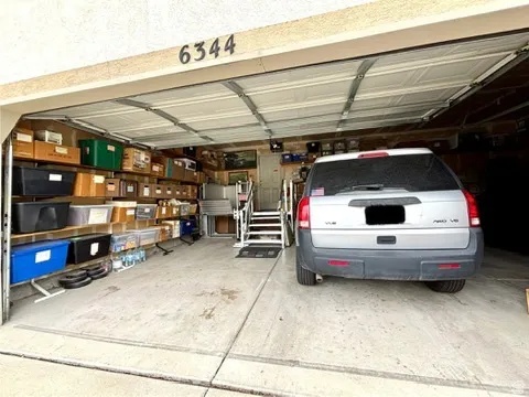 Attached three-car garage with a panel-style door