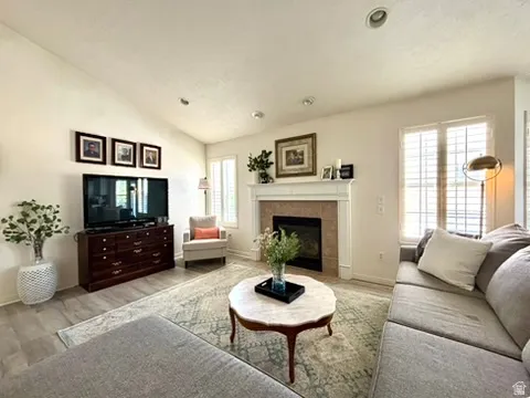 Living room featuring a vaulted ceiling and recessed lighting