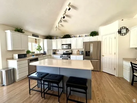 Kitchen featuring white cabinetry and a central island