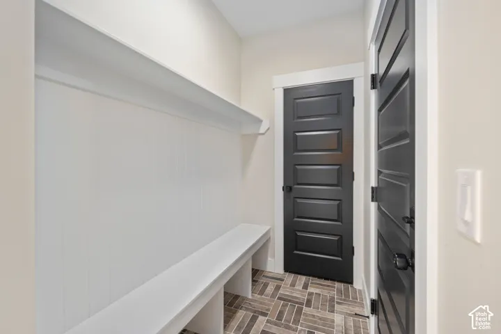 Built-in white bench and shelving with beadboard backing