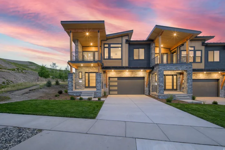 Contemporary architectural style featuring a multi-tone facade with stone and wood-look siding