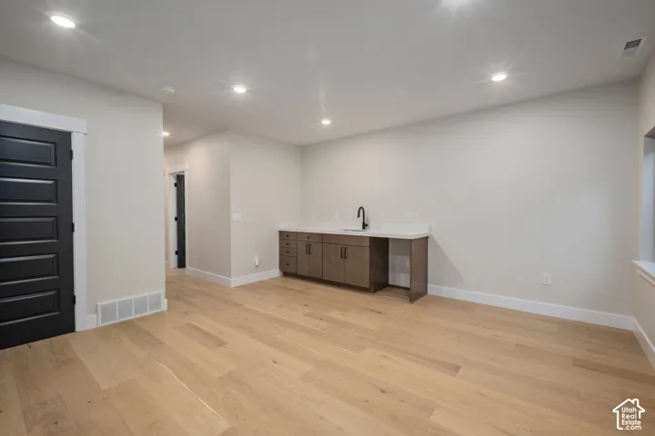 Light wood-finish flooring complements the neutral wall tones