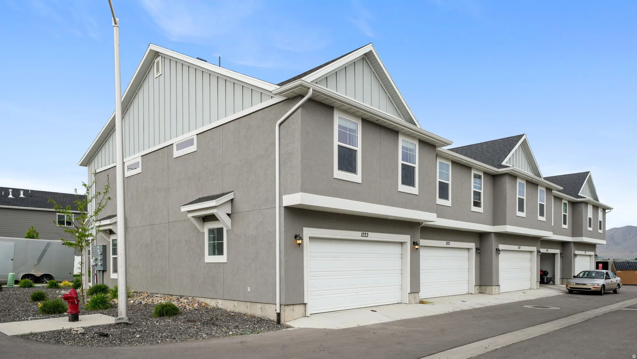 Contemporary multi-unit residence with stucco siding and gabled rooflines