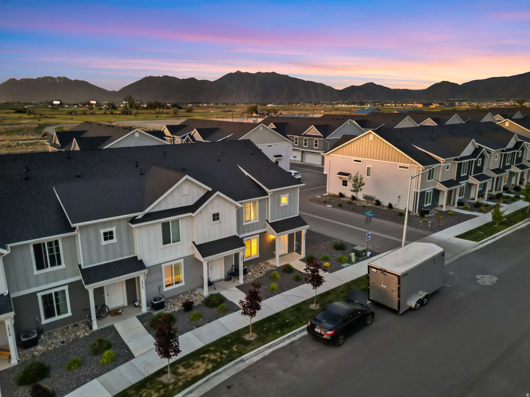 Modern townhome community featuring a consistent architectural style and dark asphalt shingles