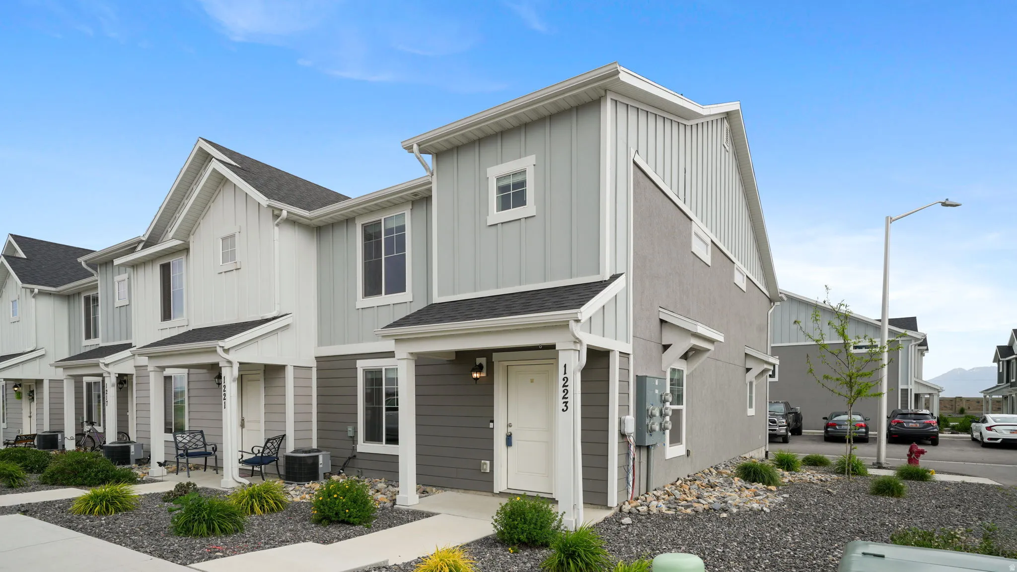 Contemporary townhome exterior featuring multi-toned siding and stucco finishes