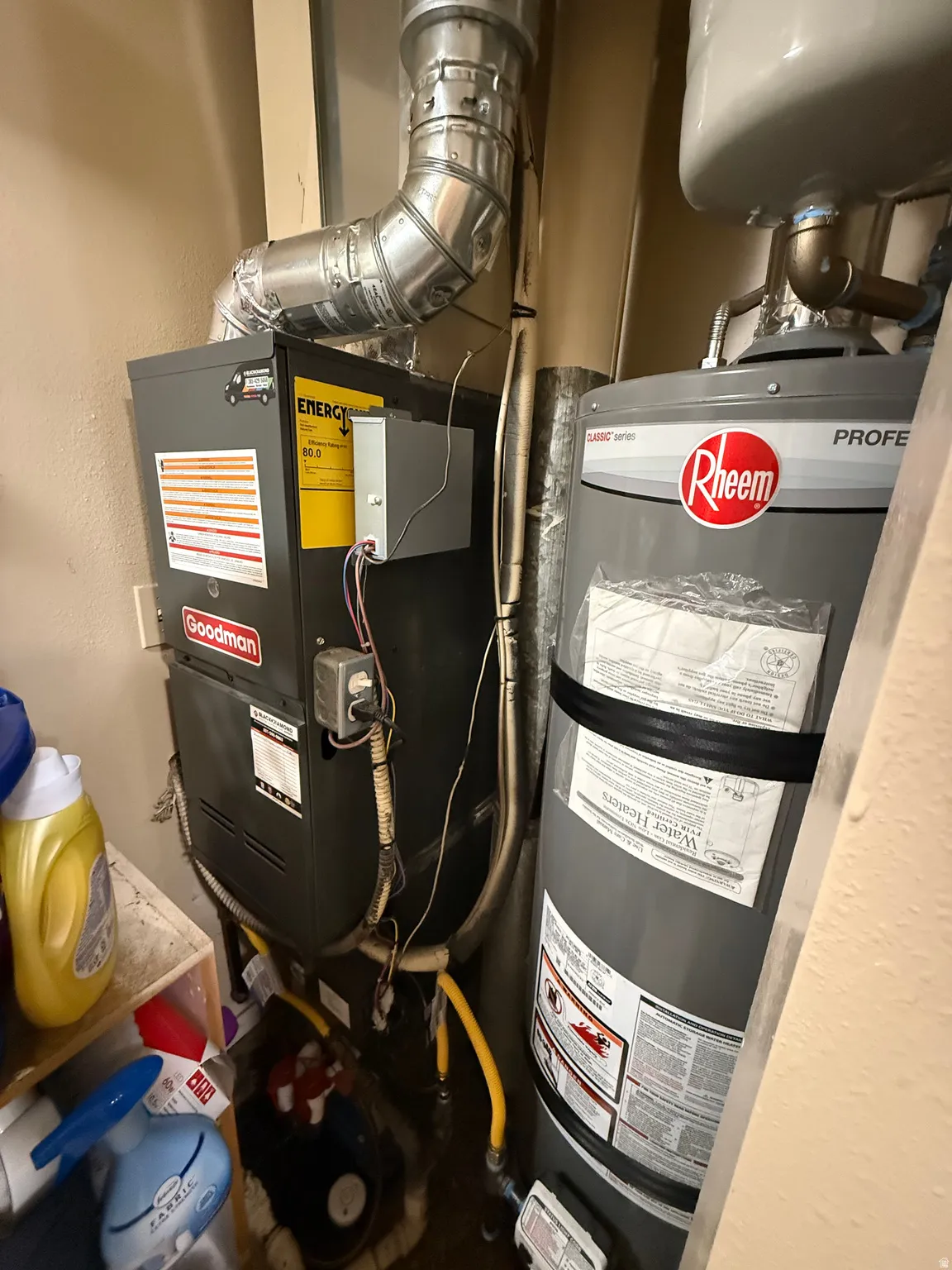 Goodman furnace unit with an Energy Star rating, Rheem water heater, and associated ventilation ductwork