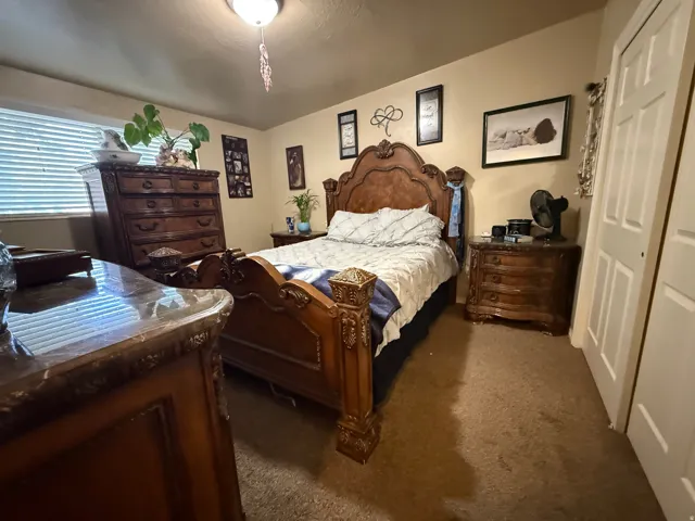 Bedroom with neutral wall color and carpet flooring